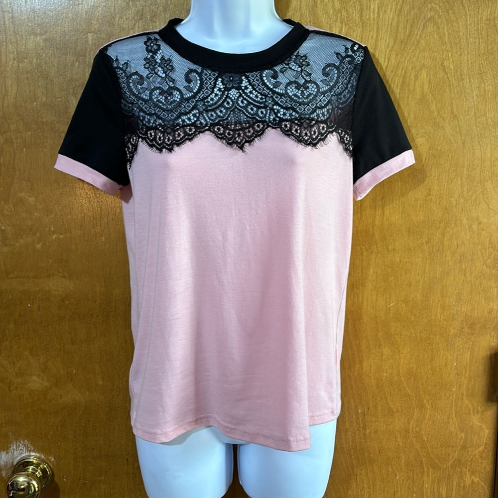 Pink tee shirt with black lace accents. Size XS. Like new.